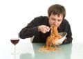 A man with eating disorder is eating noodles