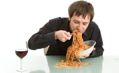 A man with eating disorder is eating noodles
