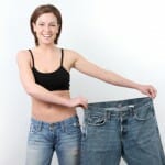 A Fit girl holding her old loose jeans