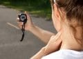 Woman holding heart rate monitor