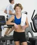 Fitness trainer standing near treadmil