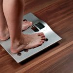Person measuring weight