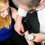 Doctor measuring blood pressure of a lady