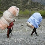 Men carrying heavy loads on back