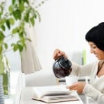 Woman pouring tea in a cup