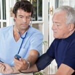 Doctor checking blood pressure of a patient