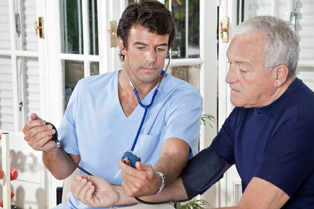 Doctor checking blood pressure of a patient