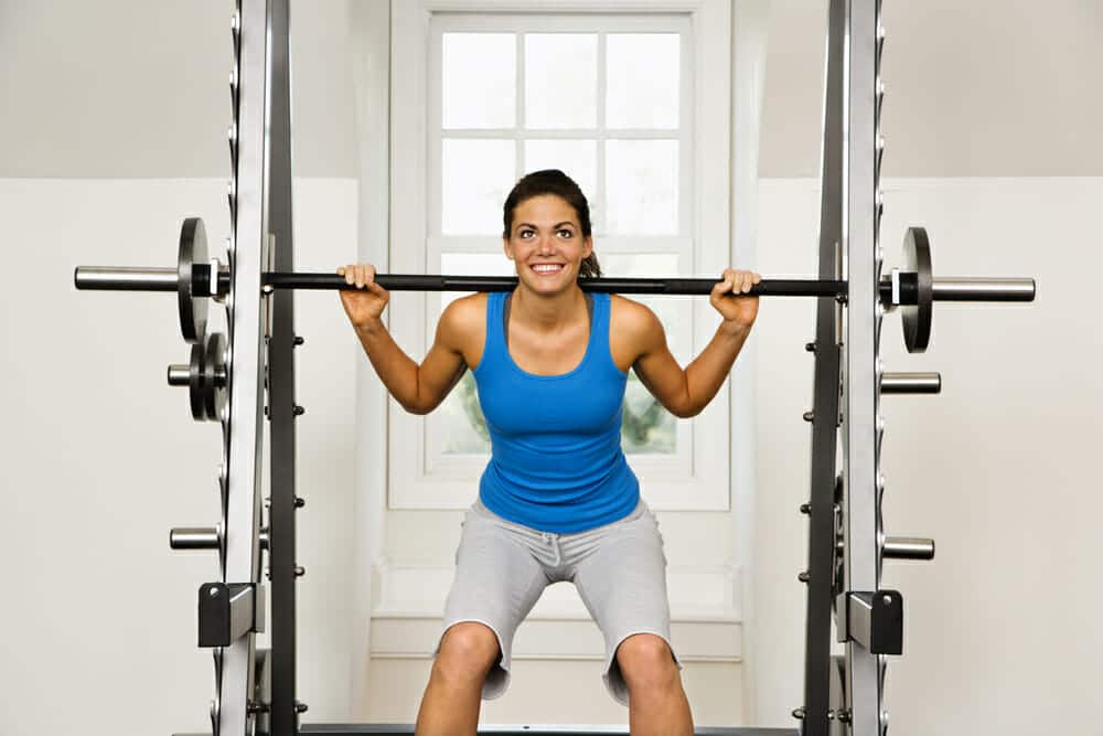 woman lifting weight in gym