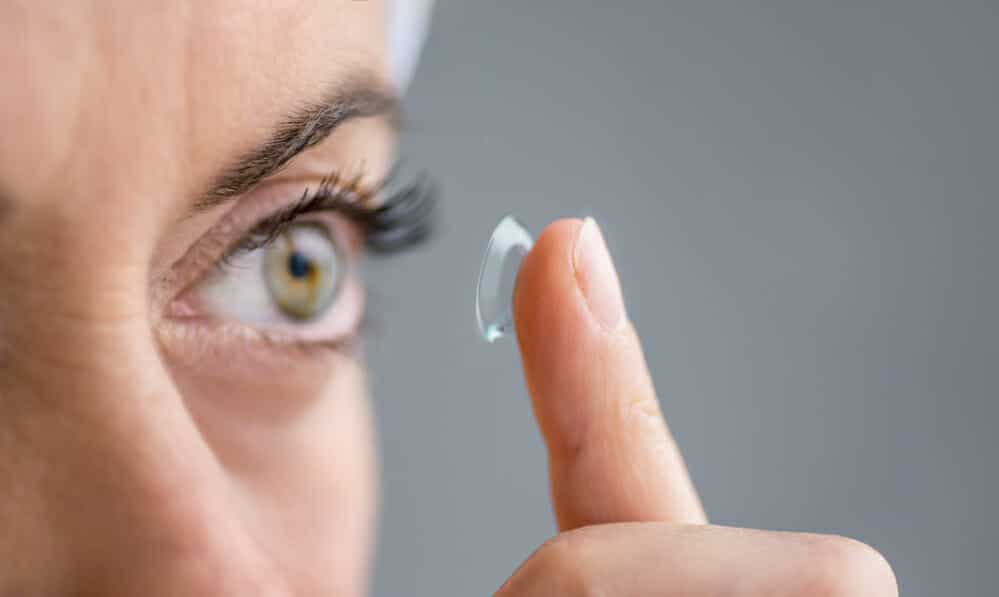 close up of a mature lady putting on contact lenses in her eyes