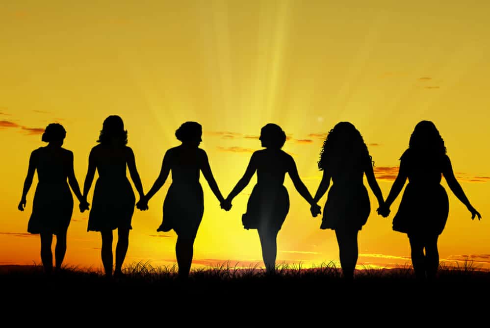 Silhouette of six young women, walking hand in hand