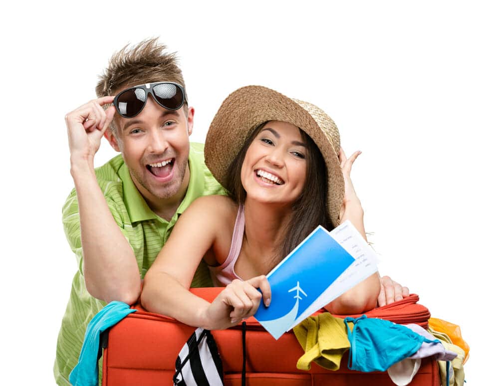 Couple packs up suitcase with clothing for departure, isolated on white. Concept of romantic vacations and lovely honeymoon