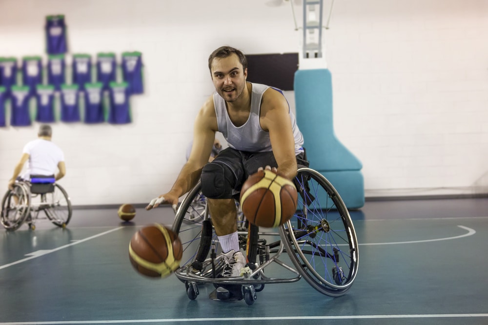 disabled sport men in action while playing indoor basketball at a basketball court