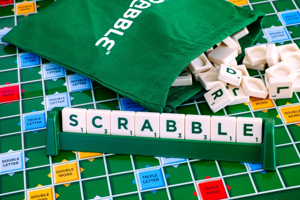 Tambov, Russian Federation - May 02, 2018 Scrabble Board Game. Word Scrabble from letter tiles in the tile rack on gameboard with drawstring letter bag. Studio shot.
