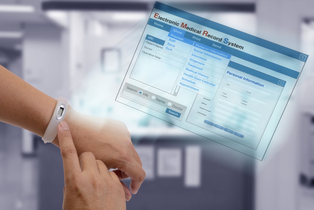 Using IT technology on hand to show patient information and medical record on screen.