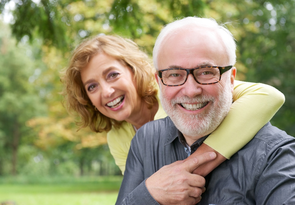 Closeup portrait of a happy older woman embracing smiling older man